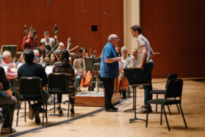 Robert Spano consults with a UGA music composition major during a reading and rehearsal of student work with the Atlanta Symphony Orchestra.